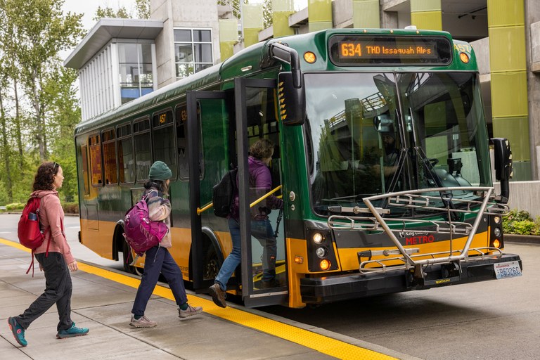 The Trailhead Direct bus drives past a car on the road. Photo courtesy of King County Parks.