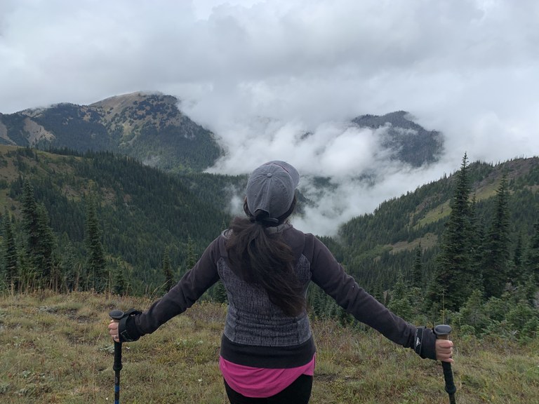 Woman holding out trekking poles. Photo by Maricar Manuel. 