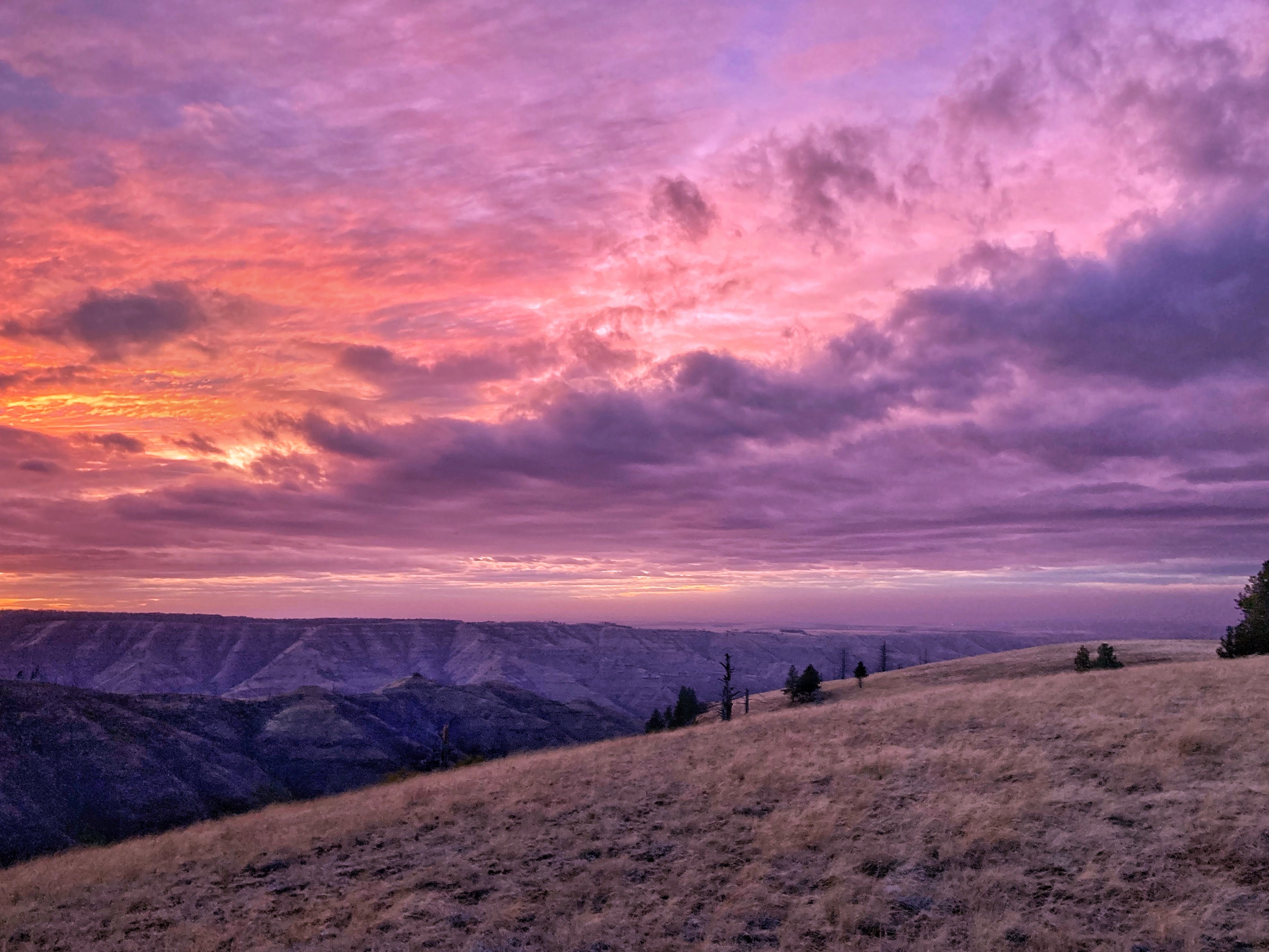 An orange and purple sky above Eastern Washington's Blue Mountains
