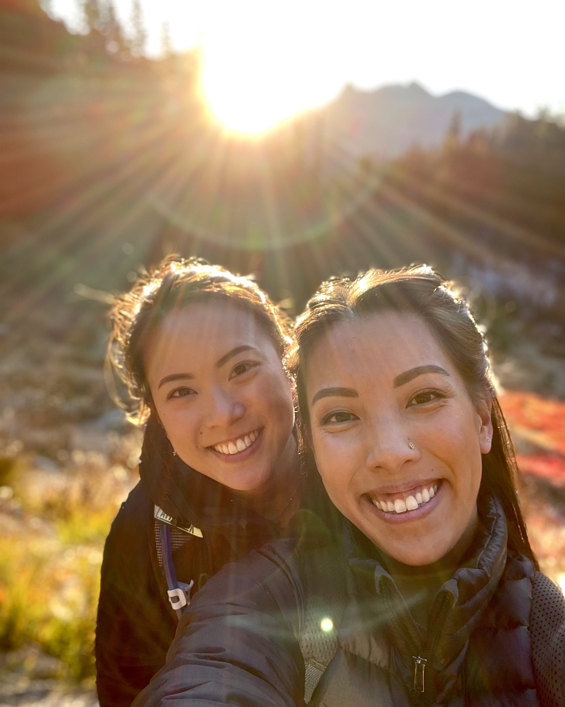 Photo by Emily Nguyen Selfie of two women on hiking trail with fall colors.
