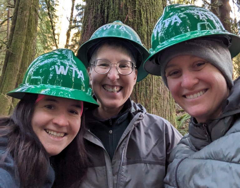 Three green hats smile for a photo at Flowing Lake Couty Park