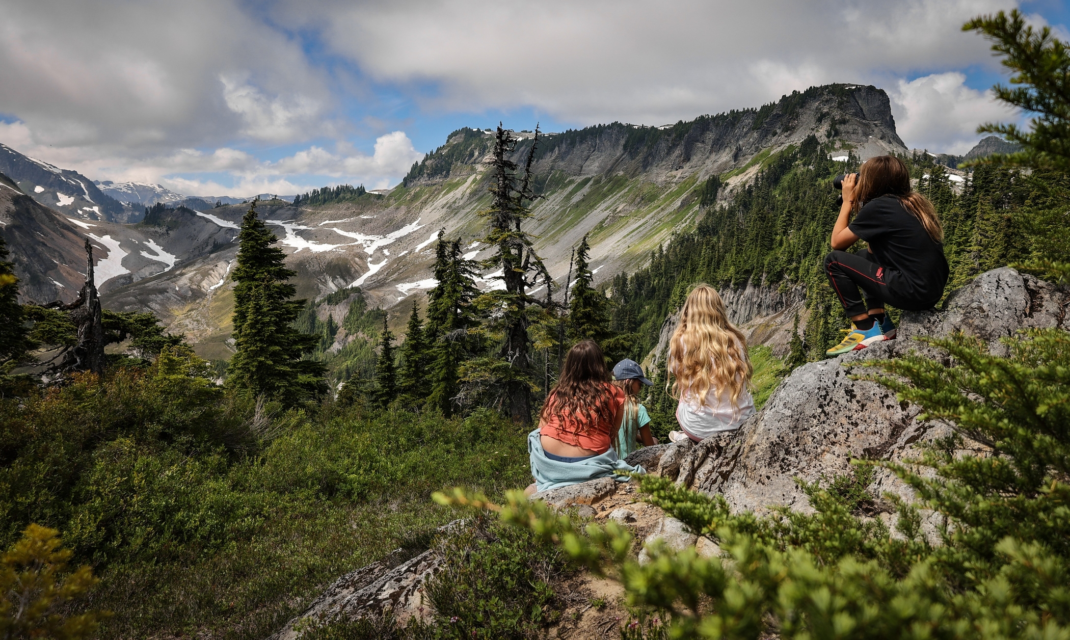 Hikers take in the summer view at Huntoon Point. Photo by Paul Brennan