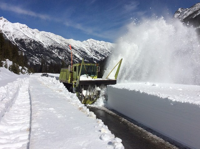 WSDOT crews make the first cut into the snowbank on Highway 20. Photo courtesy WSDOT.