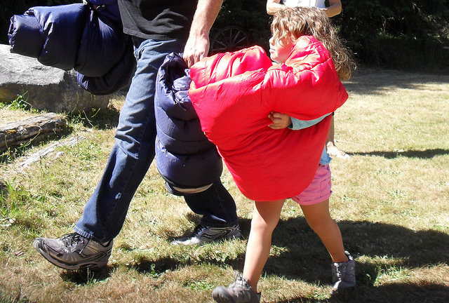 Setting up for camp on Vashon Island, Olivia is determined to help set up camp. Photo by Nicole Bahr. 