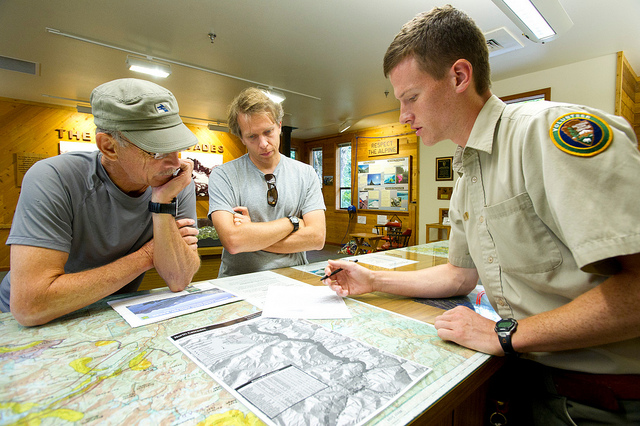 Wilderness rangers help hikers at a wilderness information center in North Cascades National Park. Photo NPS. 