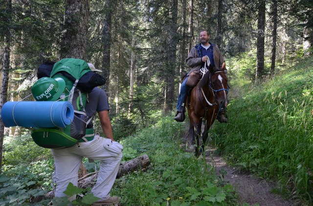 When encountering horses or other livestock, hiker should say howdy and step downhill and off the trail (if it is safe) to let them pass. Photo by Anna Roth