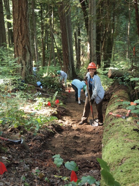 Board member Carole Bianquis, wearing her Assistant Crew Leader Orange Hat, hard at work digging trail. 