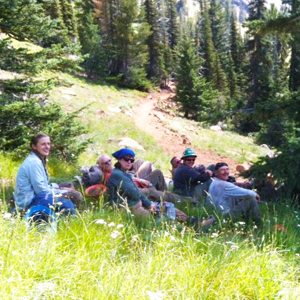 Volunteers take a break at Bean Creek. You can see the brand new trail in the background. Photo by Karen Daubert. 