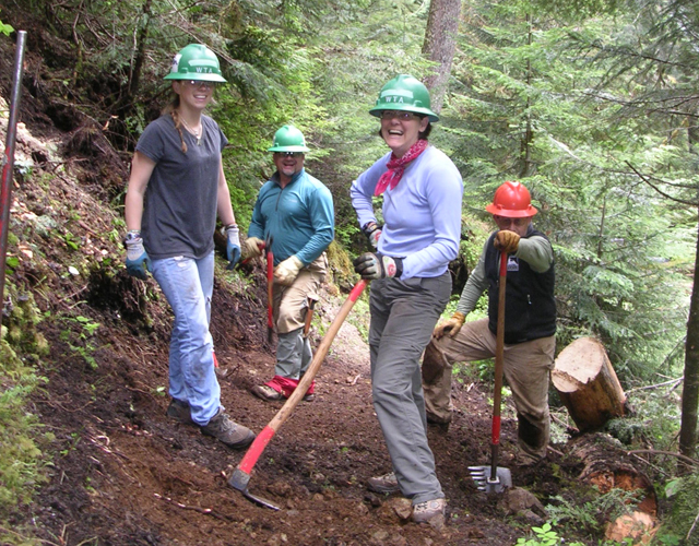 Bev laughs with a few other volunteers on a work party in 2015. Photo by Charlie Romine. 
