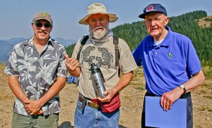 Volunteer Bob Adler, who helped coordinate the restoration of the Kelly Butte Lookout, poses with past fire lookouts Daniel Lean and John Sandor. Photo by Kim Brown.