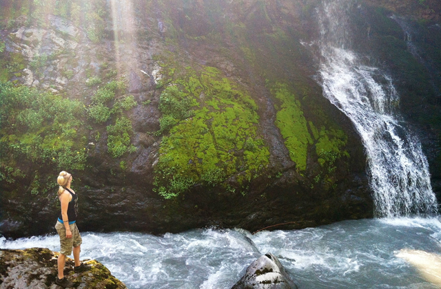 A hiker admires the towering falls at the end of the Boulder River Trail. Photo by Todd Rohn.