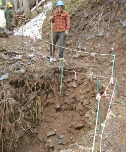 WTA crew leader John Longsworth surveys the wash-out on the Comet Falls trail. 