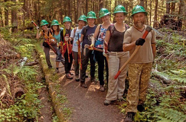 The crew lined up and ready to start some drainage work. Photo courtesy Sofia Kotselyabina. 
