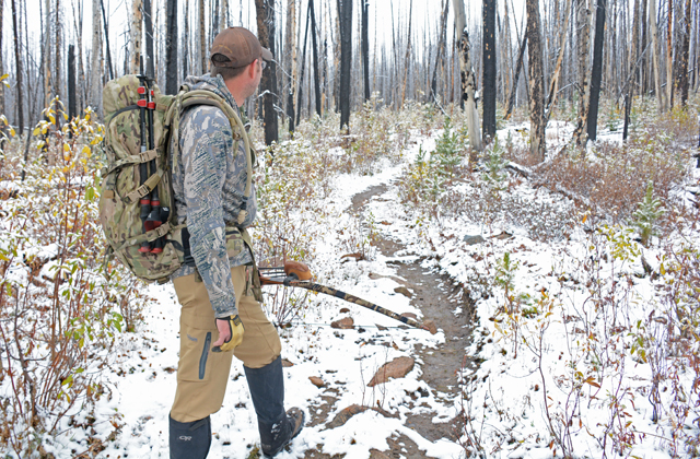 The silver-gray tree on the immediate right edge of the  trail in this image is about as close to Gregg as he needs to be for a clear shot on an animal. Photo by Anna Roth.