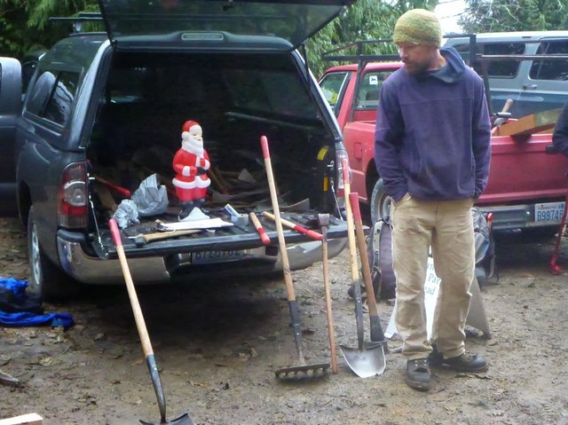 Northwest Regional Manager Arlen Bogaards looks on while Santa gives a few tips on proper use of tools at Larrabee State Park. Photo by Jon Nishimura.