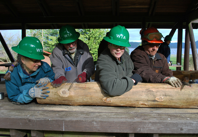 Learning to make sills (the logs that sit on the ground in a type of bridge) on Lopez Island. 