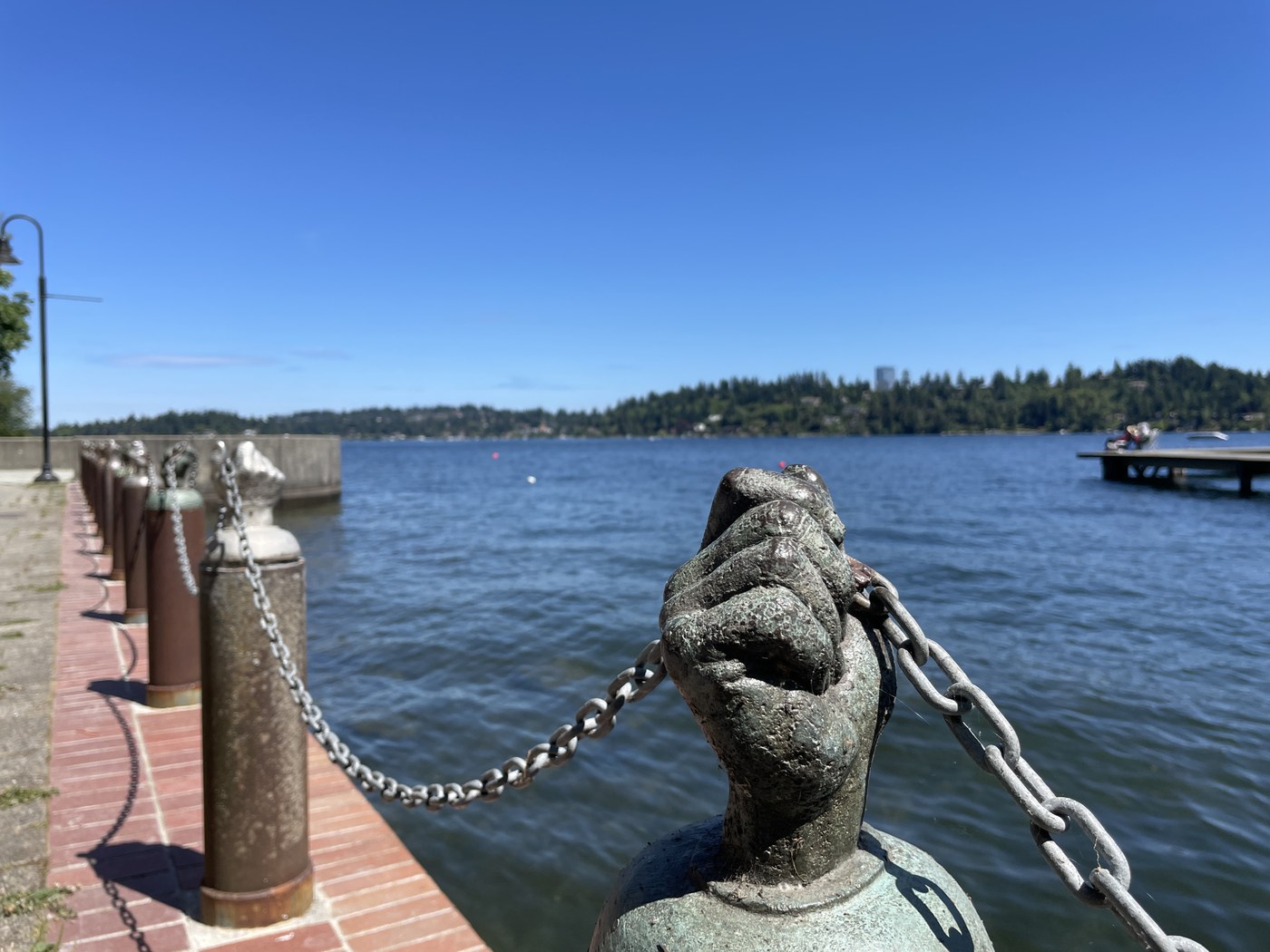 A hand statue holds up a chain fence next to the water at Luther Burbank Park. Photo by trip reporter ShutterbugFotos.